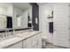 Bathroom with double vanity, white granite counters, and modern fixtures at 16573 W Alameda Rd, Surprise, AZ 85387