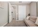 Bedroom features neutral walls, carpet flooring, closet, and tan futon with white pillows at 16573 W Alameda Rd, Surprise, AZ 85387