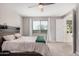 Neutral bedroom with a wooden headboard, carpet, and large window with natural light at 16573 W Alameda Rd, Surprise, AZ 85387