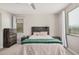 Comfortable bedroom featuring a wooden headboard, neutral tones, and natural light at 16573 W Alameda Rd, Surprise, AZ 85387