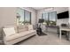 Bedroom showing neutral walls and carpet, windows with blinds, futon, and exercise equipment at 16573 W Alameda Rd, Surprise, AZ 85387