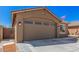 Single-Gathering home featuring a two-car garage with beautiful desert landscaping at 16573 W Alameda Rd, Surprise, AZ 85387