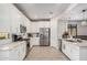 Modern kitchen featuring white cabinets, granite countertops, stainless steel appliances, and an open floor plan at 16573 W Alameda Rd, Surprise, AZ 85387