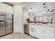 Bright kitchen featuring stainless steel appliances, granite countertops, and views of the living room at 16573 W Alameda Rd, Surprise, AZ 85387