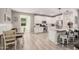 Bright kitchen with white cabinets, granite countertops, stainless steel appliances, and breakfast bar seating at 16573 W Alameda Rd, Surprise, AZ 85387