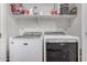 Laundry room with a white Maytag washer and dryer at 16573 W Alameda Rd, Surprise, AZ 85387