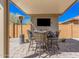 Covered patio with outdoor dining and a mounted television at 16573 W Alameda Rd, Surprise, AZ 85387