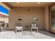 Covered patio featuring two chairs, small table, and paver flooring at 16573 W Alameda Rd, Surprise, AZ 85387