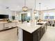 Bright, open kitchen featuring a large island with granite countertops and modern pendant lighting at 17633 W Pierson St, Goodyear, AZ 85395