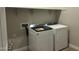 Picture displays modern laundry area with new front-load washer and dryer appliances with sleek design and color at 17633 W Pierson St, Goodyear, AZ 85395