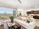 Open-concept living room with comfortable seating, stylish decor, and sliding glass doors to the patio at 17633 W Pierson St, Goodyear, AZ 85395