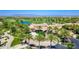 An aerial showcases the golf course and community clubhouse with palm trees in a great location at 187 E Santa Lucia Ln, Queen Creek, AZ 85140