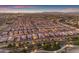 Stunning aerial view of a well-planned community with illuminated streets and beautiful homes at twilight at 187 E Santa Lucia Ln, Queen Creek, AZ 85140