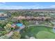 Stunning aerial view showcasing the community pool, clubhouse, green spaces, and surrounding mountains at 187 E Santa Lucia Ln, Queen Creek, AZ 85140