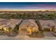 Stunning aerial view of a suburban home nestled within a well-planned community at twilight at 187 E Santa Lucia Ln, Queen Creek, AZ 85140