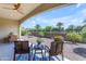 Serene backyard features a covered patio with seating, lush landscaping, and a tranquil desert aesthetic at 187 E Santa Lucia Ln, Queen Creek, AZ 85140