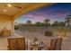 Inviting covered patio offering a beautiful outdoor space with seating and a view of the landscaped backyard at 187 E Santa Lucia Ln, Queen Creek, AZ 85140
