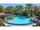 A resort-style pool is surrounded by swaying palm trees, lounge chairs, and private cabanas at 187 E Santa Lucia Ln, Queen Creek, AZ 85140