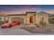 Charming home with two-car garage, attractive desert landscaping, and a bright red sports car at 187 E Santa Lucia Ln, Queen Creek, AZ 85140