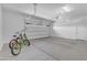 Clean, bright garage featuring epoxy flooring, overhead storage and space for two cars and bikes at 187 E Santa Lucia Ln, Queen Creek, AZ 85140