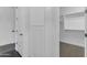 Hallway view with storage and dark wood floors, and white trim at 187 E Santa Lucia Ln, Queen Creek, AZ 85140