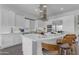 Modern white kitchen boasting sleek appliances, a stylish range hood, and a spacious island for food preparation at 187 E Santa Lucia Ln, Queen Creek, AZ 85140