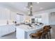 Modern white kitchen with a large island, stainless steel appliances, and countertop dining at 187 E Santa Lucia Ln, Queen Creek, AZ 85140