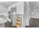 Bright, white kitchen features stainless steel appliances and convenient pull-out shelving at 187 E Santa Lucia Ln, Queen Creek, AZ 85140