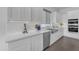 Bright kitchen boasting sleek white cabinetry, stainless steel appliances, and a spacious countertop for gourmet cooking at 187 E Santa Lucia Ln, Queen Creek, AZ 85140
