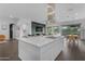 Modern kitchen boasting a spacious white island, stainless steel range hood, and open layout for gatherings at 187 E Santa Lucia Ln, Queen Creek, AZ 85140