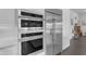 Modern kitchen features stainless steel appliances including wall ovens, a refrigerator, and sleek white cabinetry at 187 E Santa Lucia Ln, Queen Creek, AZ 85140