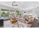 Bright living area featuring a sectional sofa, large windows, and stylish decor, perfect for relaxation and entertaining at 187 E Santa Lucia Ln, Queen Creek, AZ 85140