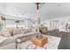 Open-concept living room seamlessly connects to the kitchen, featuring a large sectional sofa and modern furnishings at 187 E Santa Lucia Ln, Queen Creek, AZ 85140