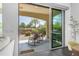 Charming patio with rocking chairs, barbecue, and views of the serene landscaped backyard and clear sky at 187 E Santa Lucia Ln, Queen Creek, AZ 85140