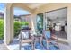 Covered patio with cozy seating, a grill, and views of the lush backyard, perfect for outdoor living at 187 E Santa Lucia Ln, Queen Creek, AZ 85140