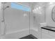 Bright, white tiled shower with a glass door, a built-in bench, and black tiled flooring at 187 E Santa Lucia Ln, Queen Creek, AZ 85140