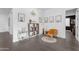Cozy sitting area with an orange velvet chair, decorative shelf, and stylish accents for comfortable living at 187 E Santa Lucia Ln, Queen Creek, AZ 85140