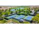 Aerial view features community tennis courts, green spaces, a putting green, and neighborhood homes at 187 E Santa Lucia Ln, Queen Creek, AZ 85140