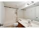 Clean bathroom featuring a single sink vanity, large mirror and a shower/tub at 18811 N 19Th Ave # 3015, Phoenix, AZ 85027