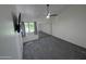 A carpeted bedroom featuring a window, ceiling fan, and a mirrored closet at 18811 N 19Th Ave # 3015, Phoenix, AZ 85027