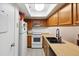 Well-lit kitchen with white appliances and light-colored wooden cabinets at 18811 N 19Th Ave # 3015, Phoenix, AZ 85027
