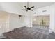 Loft featuring neutral walls, sliding mirrored closet doors, gray carpet, and a ceiling fan at 18811 N 19Th Ave # 3015, Phoenix, AZ 85027