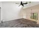 Spacious loft featuring high ceilings, natural light, modern ceiling fan, and soft gray carpeting at 18811 N 19Th Ave # 3015, Phoenix, AZ 85027