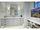 Bright bathroom featuring double sinks, elegant fixtures, and a large mirror at 18916 N 98Th St # 3709, Scottsdale, AZ 85255