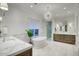Bright bathroom featuring double vanities, a freestanding tub, and elegant lighting fixtures at 18916 N 98Th St # 3709, Scottsdale, AZ 85255
