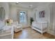Bright Bedroom with a crib, cozy chair, and soft, neutral decor at 18916 N 98Th St # 3709, Scottsdale, AZ 85255