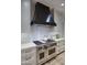 Close-up of the kitchen area with a stainless steel range hood and modern appliances at 18916 N 98Th St # 3709, Scottsdale, AZ 85255