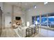 Stylish living room featuring a stone fireplace, high ceilings, and sliding doors to the outdoor patio at 18916 N 98Th St # 3709, Scottsdale, AZ 85255