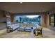 Spacious covered outdoor lounge area with a full kitchen, comfortable seating, and fireplace at 18916 N 98Th St # 3709, Scottsdale, AZ 85255