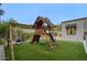 Backyard with a wooden playset and lush green lawn, perfect for outdoor fun at 18916 N 98Th St # 3709, Scottsdale, AZ 85255